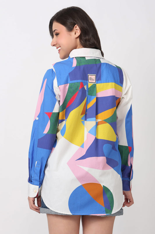 Woman wearing a colorful abstract patterned dress on a white background