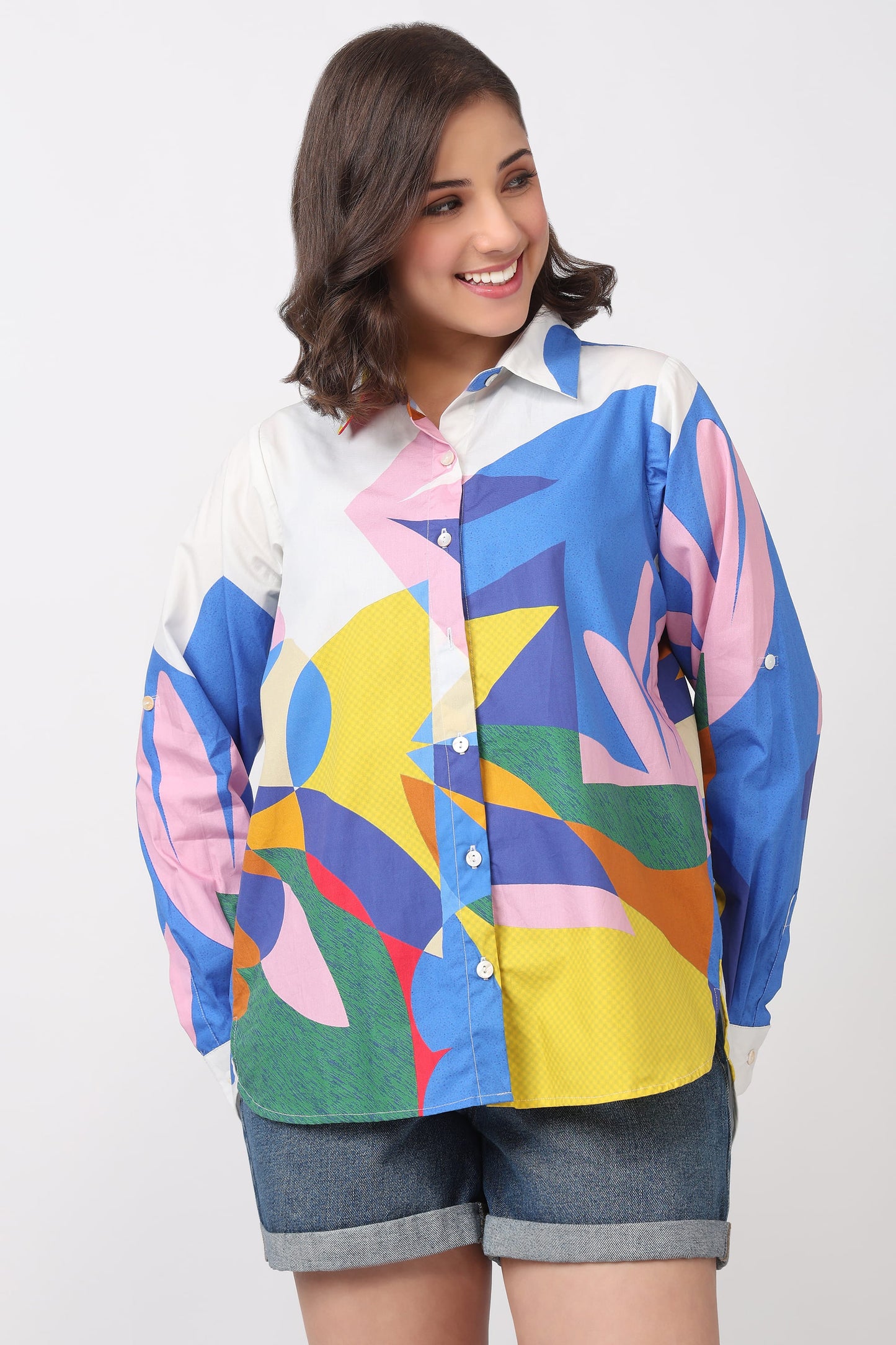 Woman wearing a colorful geometric patterned shirt on a white background