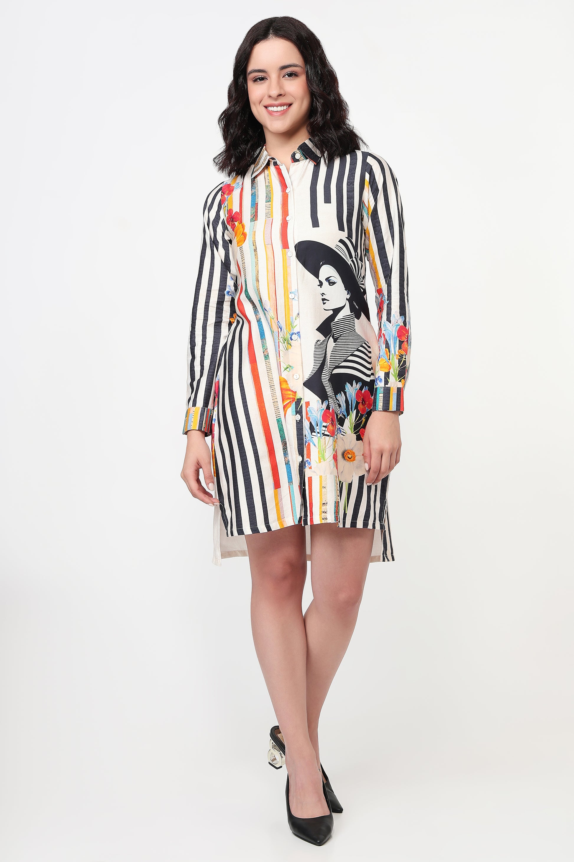 Woman wearing a colorful striped dress with a graphic design on a white background