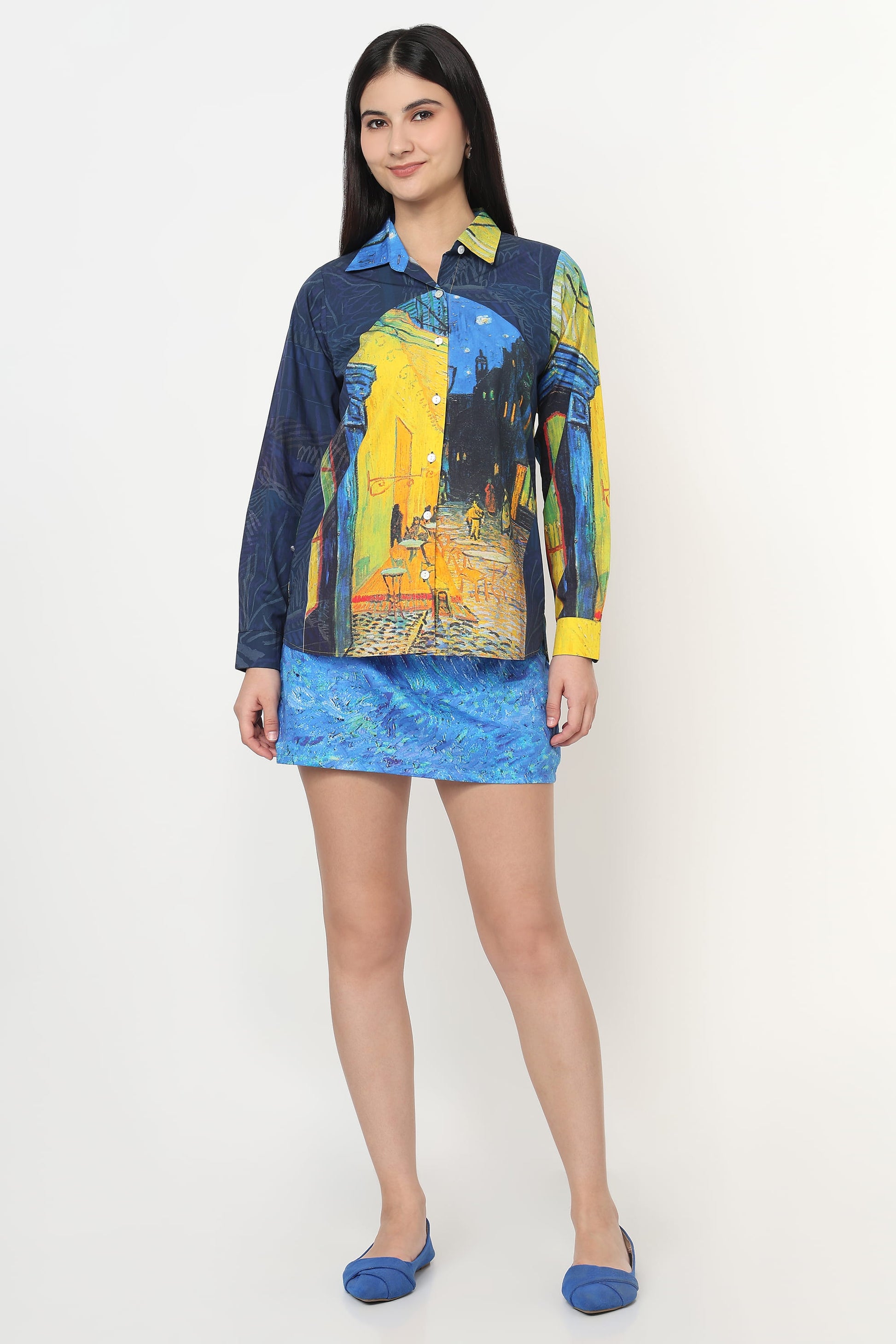 Woman wearing a colorful shirt and blue skirt on a white background
