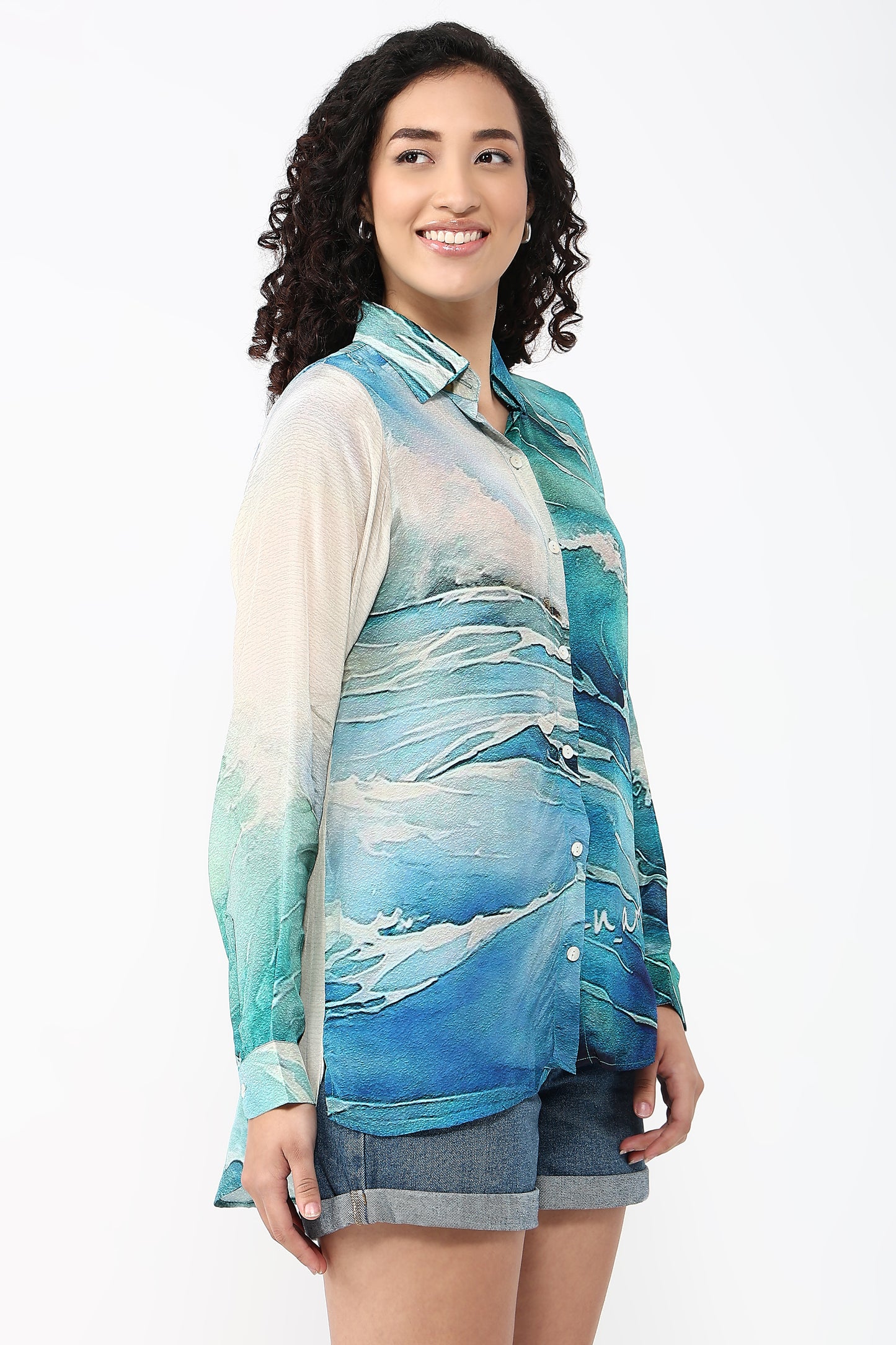 Woman wearing a blue and white patterned shirt with a white background