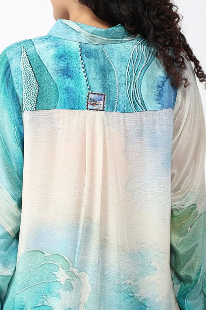 Teal and white fabric with a brand label, possibly a scarf or shawl.
