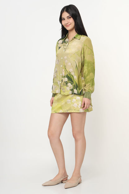 Woman wearing a green floral co-ord set on a white background