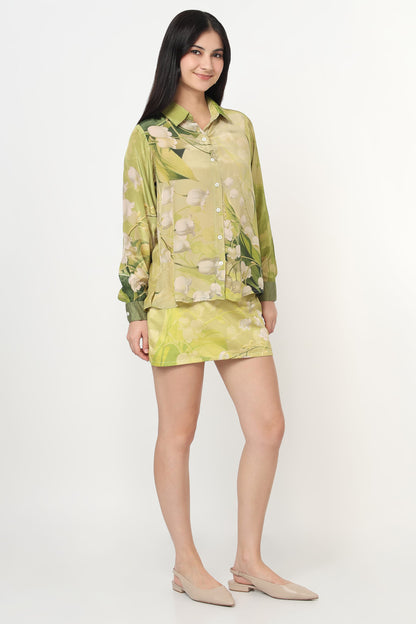 Woman wearing a green floral co-ord set on a white background