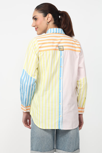 Woman wearing a colorful striped shirt on a white background