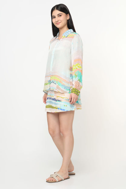 Woman wearing a colorful co-ord set on a white background