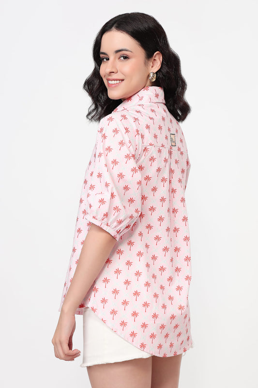 Woman wearing a pink floral patterned shirt on a white background