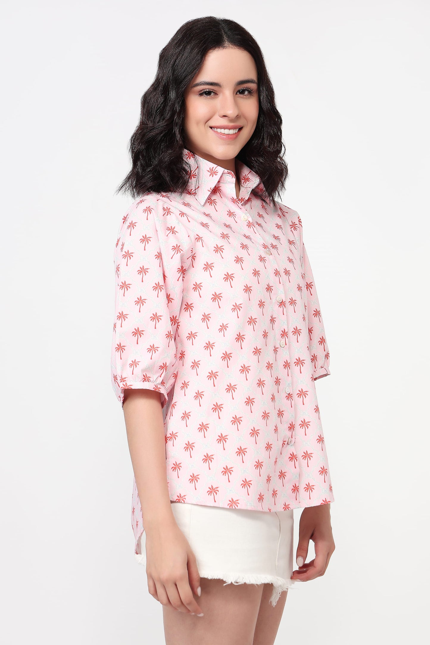 Woman wearing a pink floral blouse on a white background