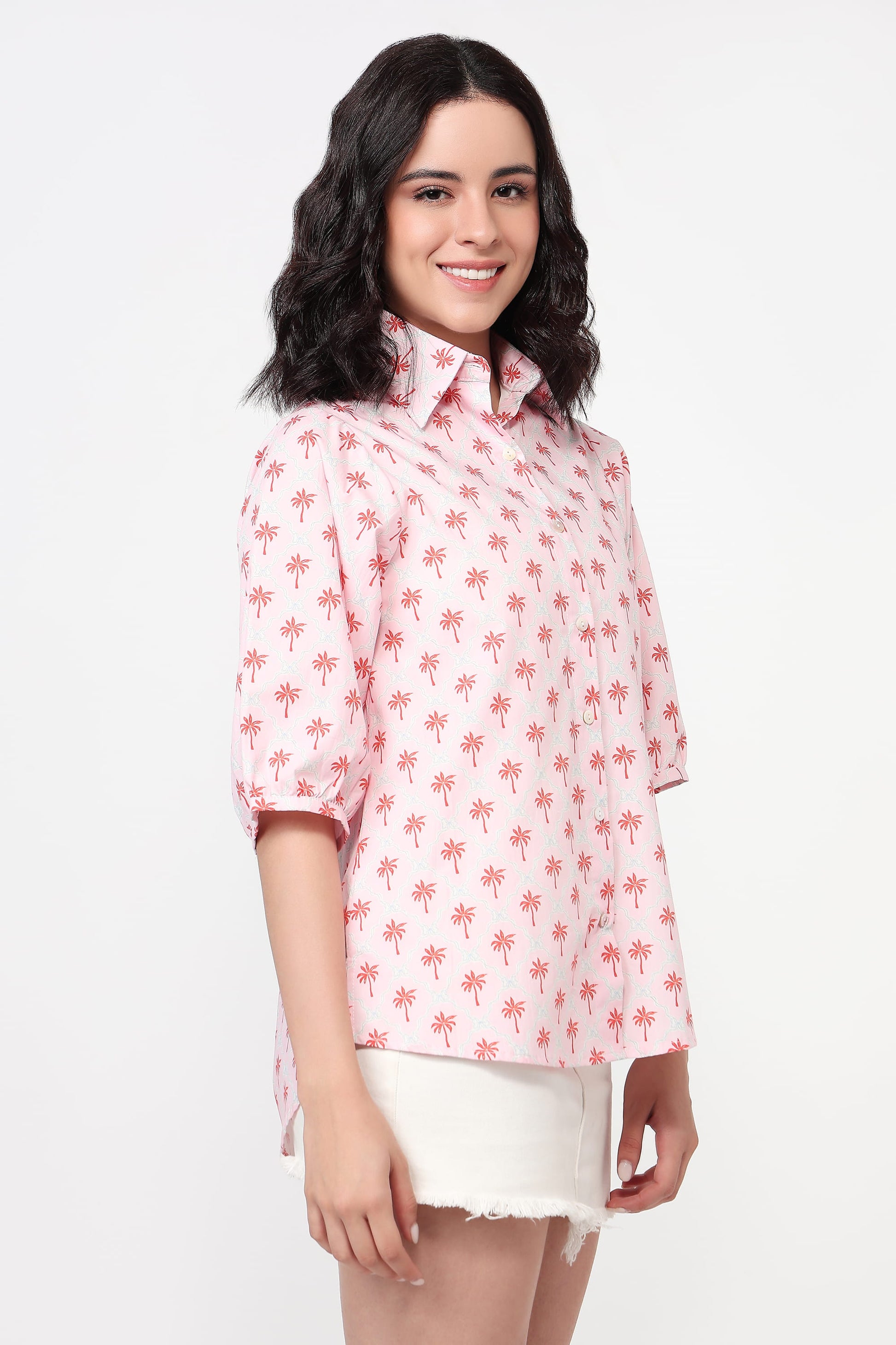Woman wearing a pink floral blouse on a white background
