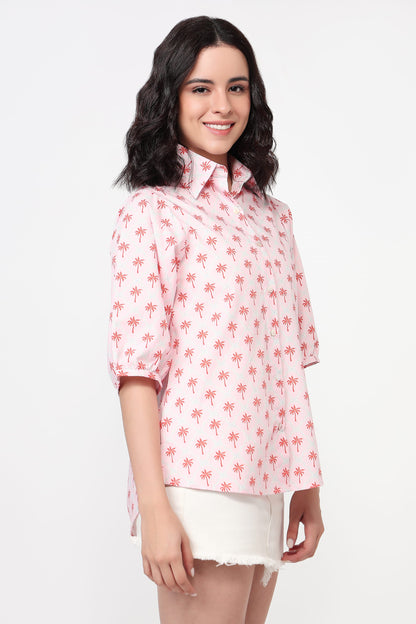 Woman wearing a pink floral blouse on a white background