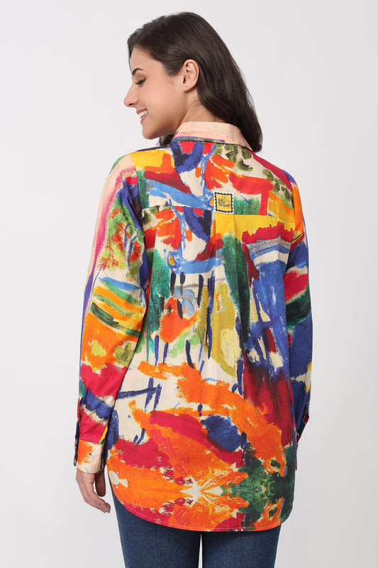 Woman wearing a colorful abstract patterned shirt on a white background