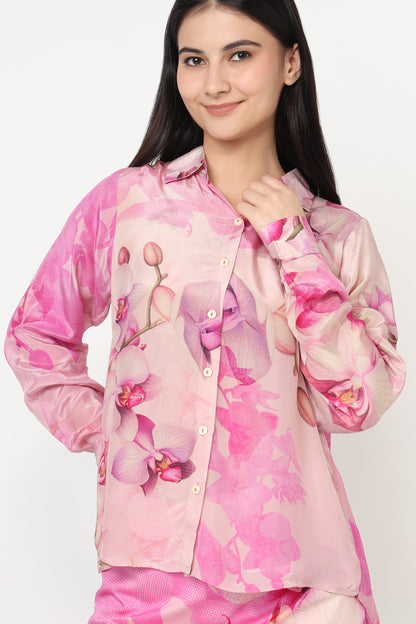 Woman wearing a pink floral shirt with a white background
