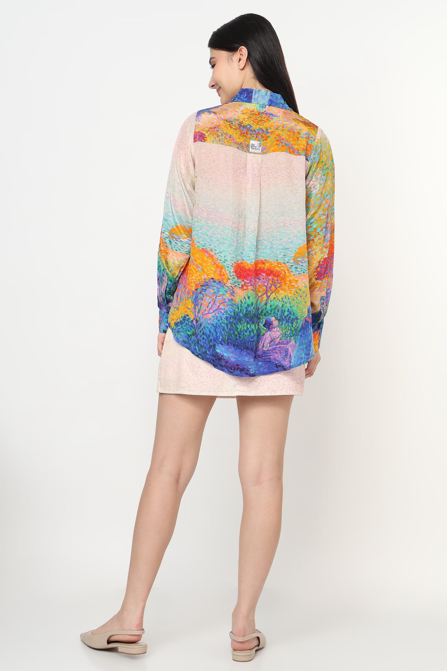 Woman wearing a colorful floral blouse with a white background