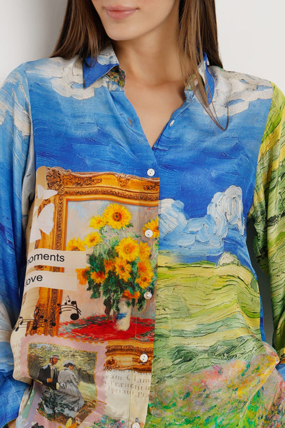 A close-up of a model wearing a long-sleeve button-up shirt with a Van Gogh-inspired print. The shirt features a vibrant blue sky and landscape with sunflowers, green fields, and a large golden picture frame collage on the front.