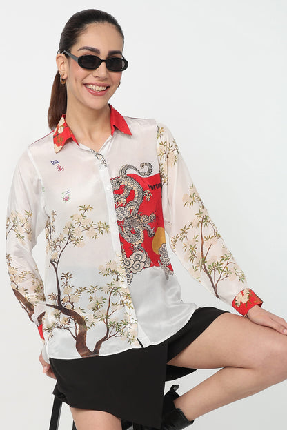 Woman wearing a colorful patterned shirt with a white background