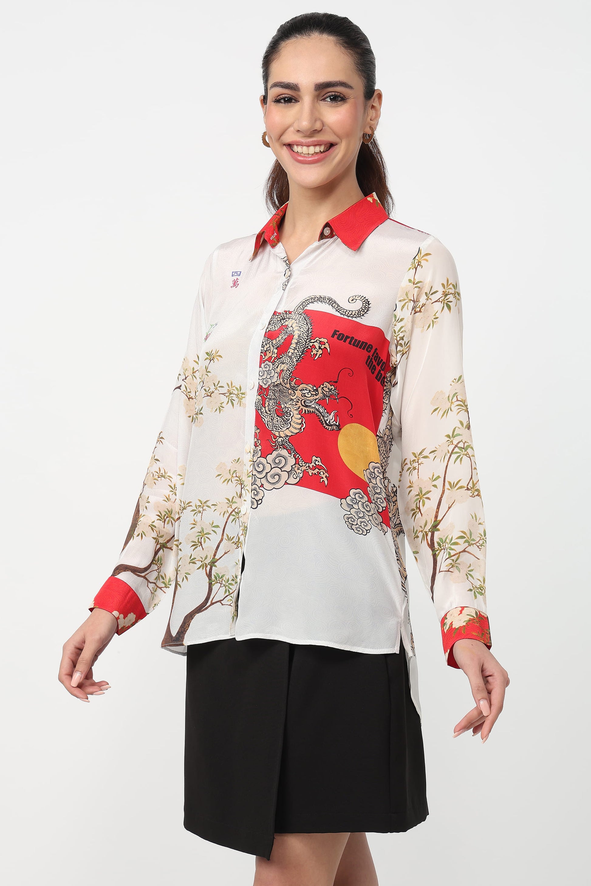 Woman wearing a white shirt with red and black dragon design on a white background