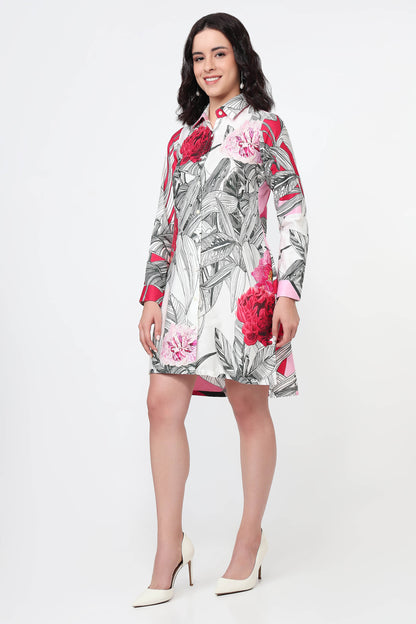 Woman wearing a pink dress with abstract patterns on a white background