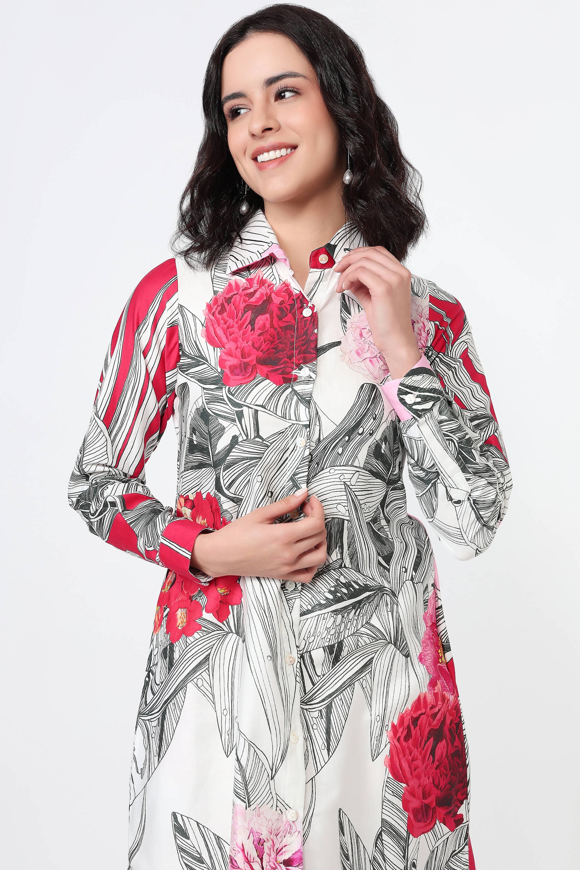 Woman wearing a pink dress with abstract patterns on a white background