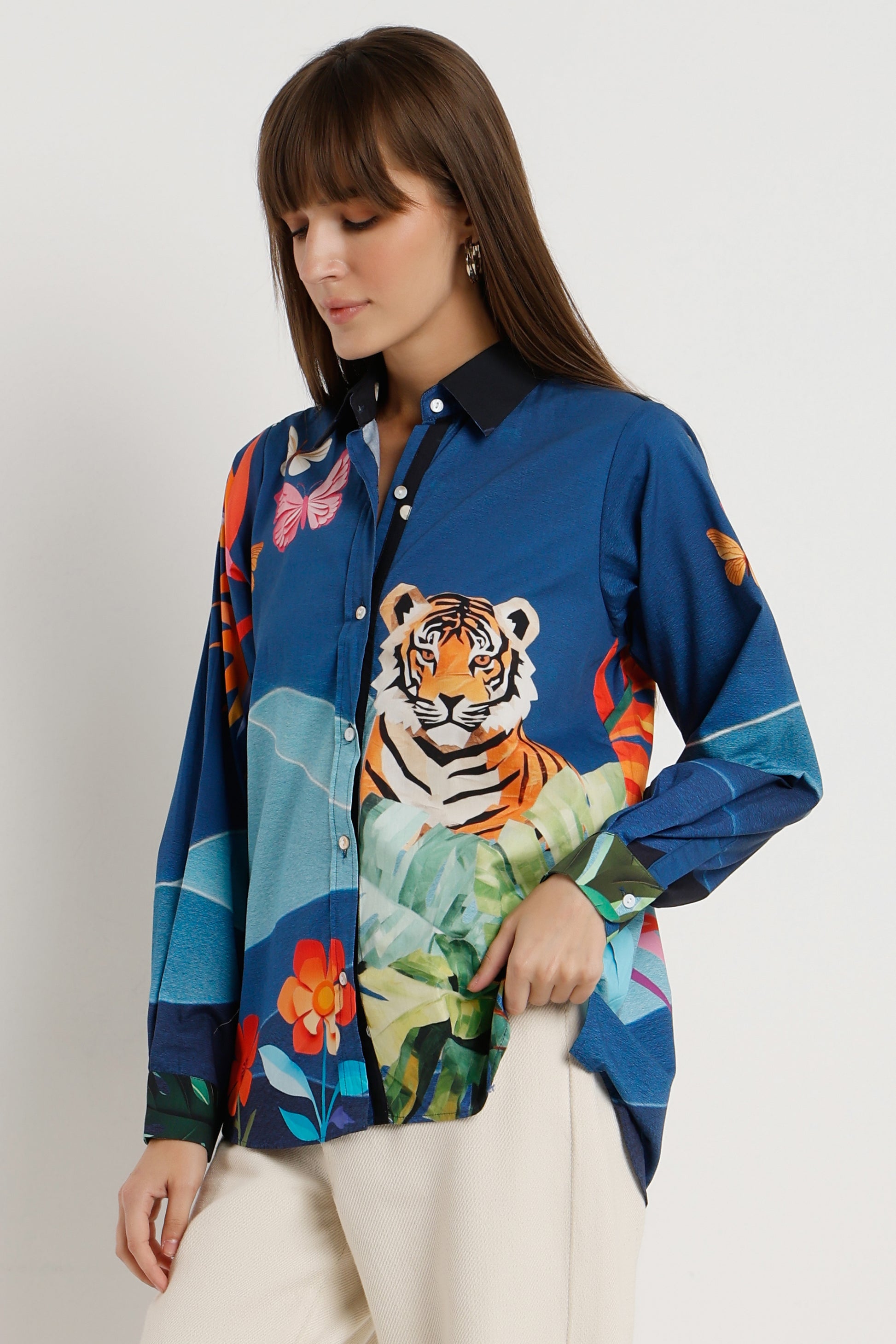 Woman wearing a colorful shirt with a tiger design on a white background
