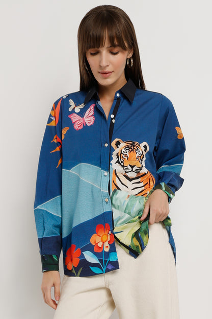 Woman wearing a colorful shirt with a tiger design on a white background