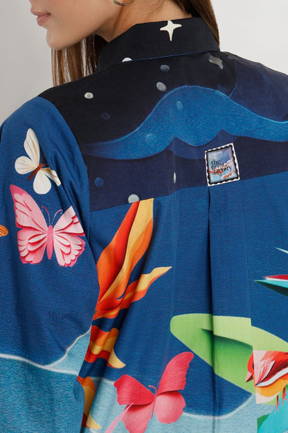Close-up of a colorful shirt with butterfly and floral designs on a plain background