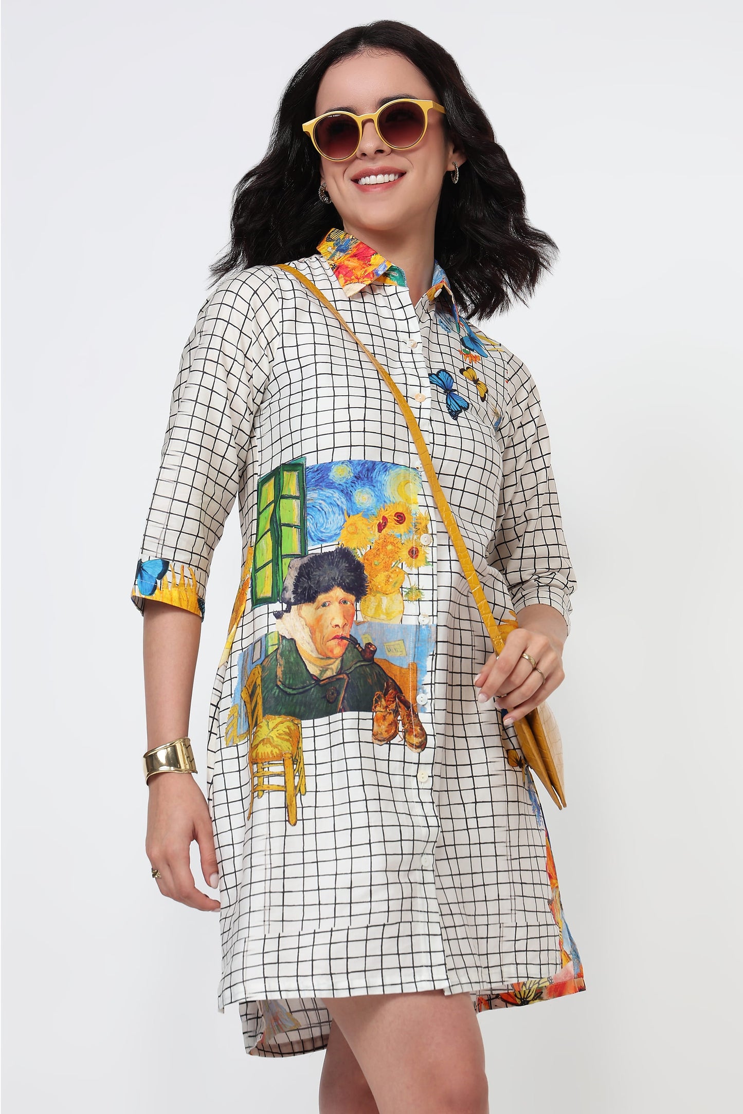 Woman wearing a colorful dress with artistic designs on a white background