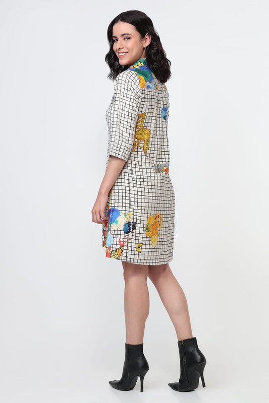 Woman wearing a checkered dress with colorful animal appliqués on a white background