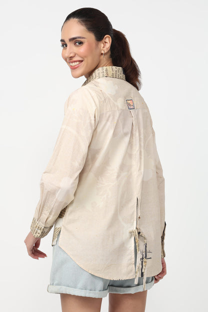Woman wearing a beige jacket with a visible brand logo on a white background