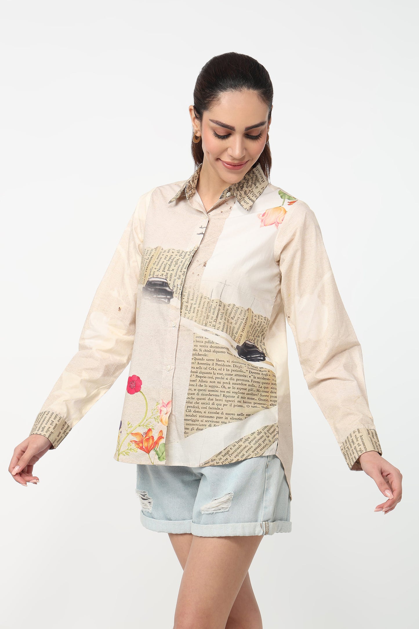 Woman wearing a patchwork shirt with floral and abstract designs on a white background