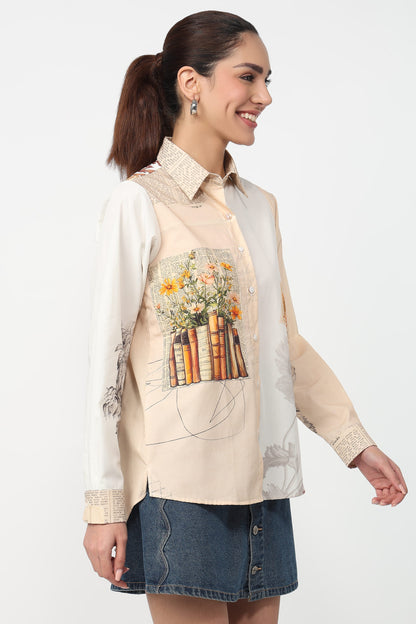 Woman wearing a beige shirt with floral and book design on a white background