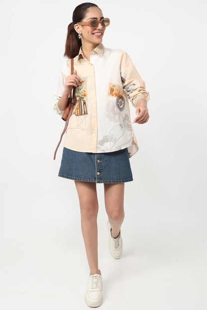 Woman wearing a cream shirt with floral patterns and a denim skirt on a white background