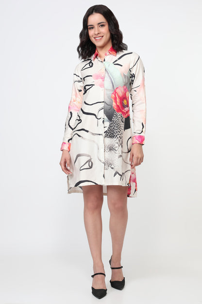 Woman wearing a floral and abstract patterned dress on a white background