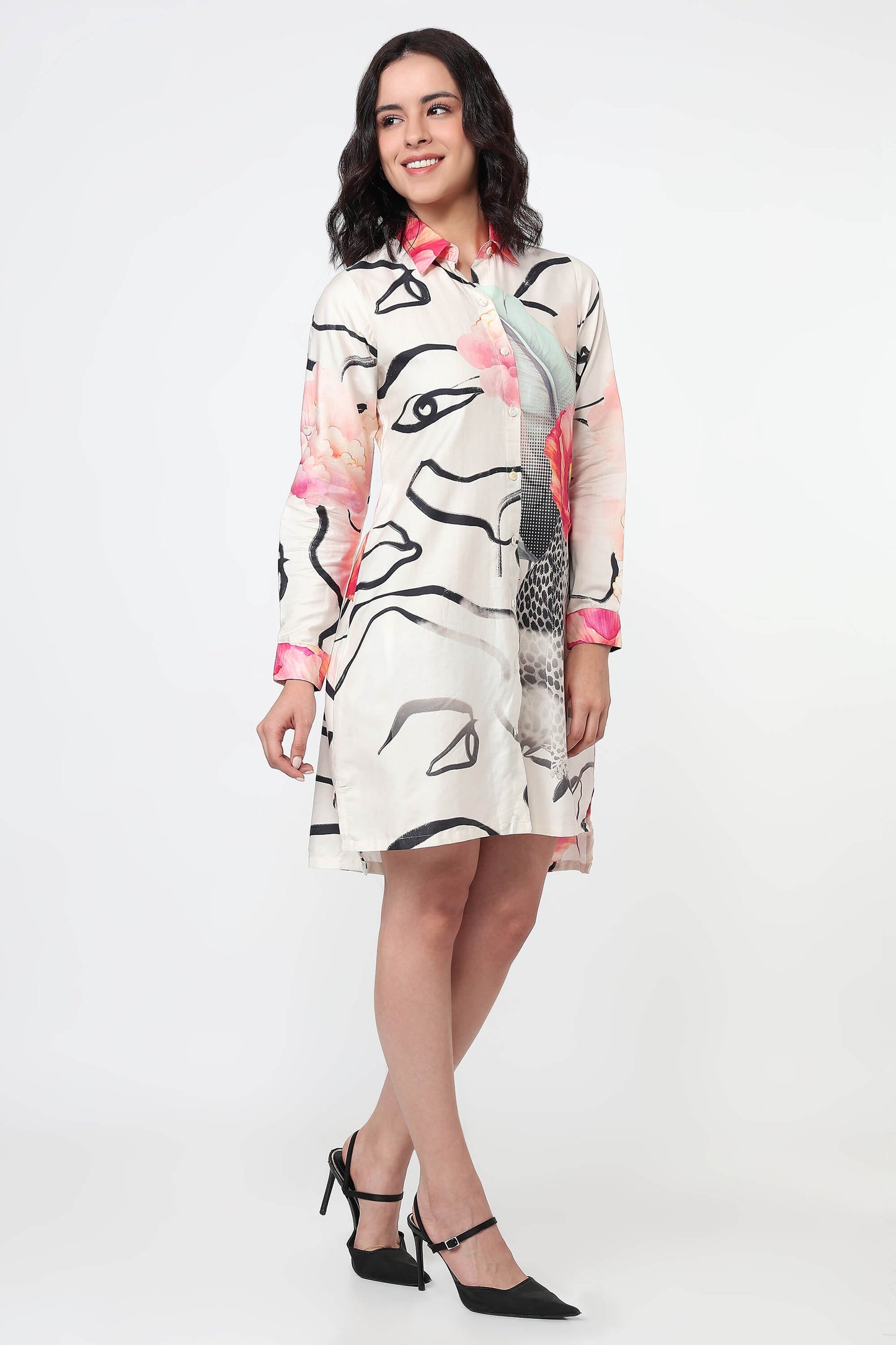 Woman wearing a white dress with abstract black and pink patterns on a white background
