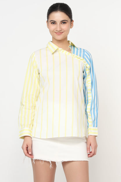 Woman wearing a yellow and blue striped shirt with a white skirt on a white background