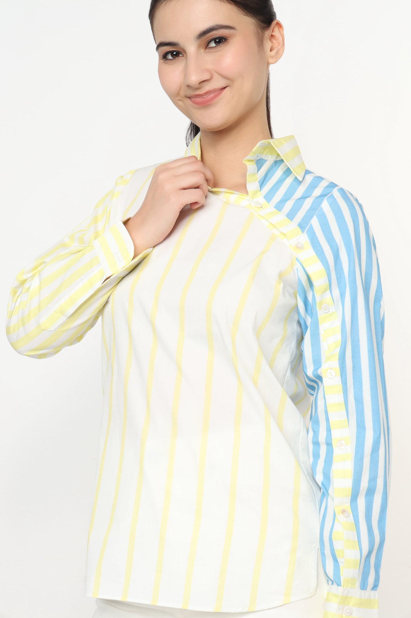 Woman wearing a striped shirt with yellow and blue vertical lines on a white background