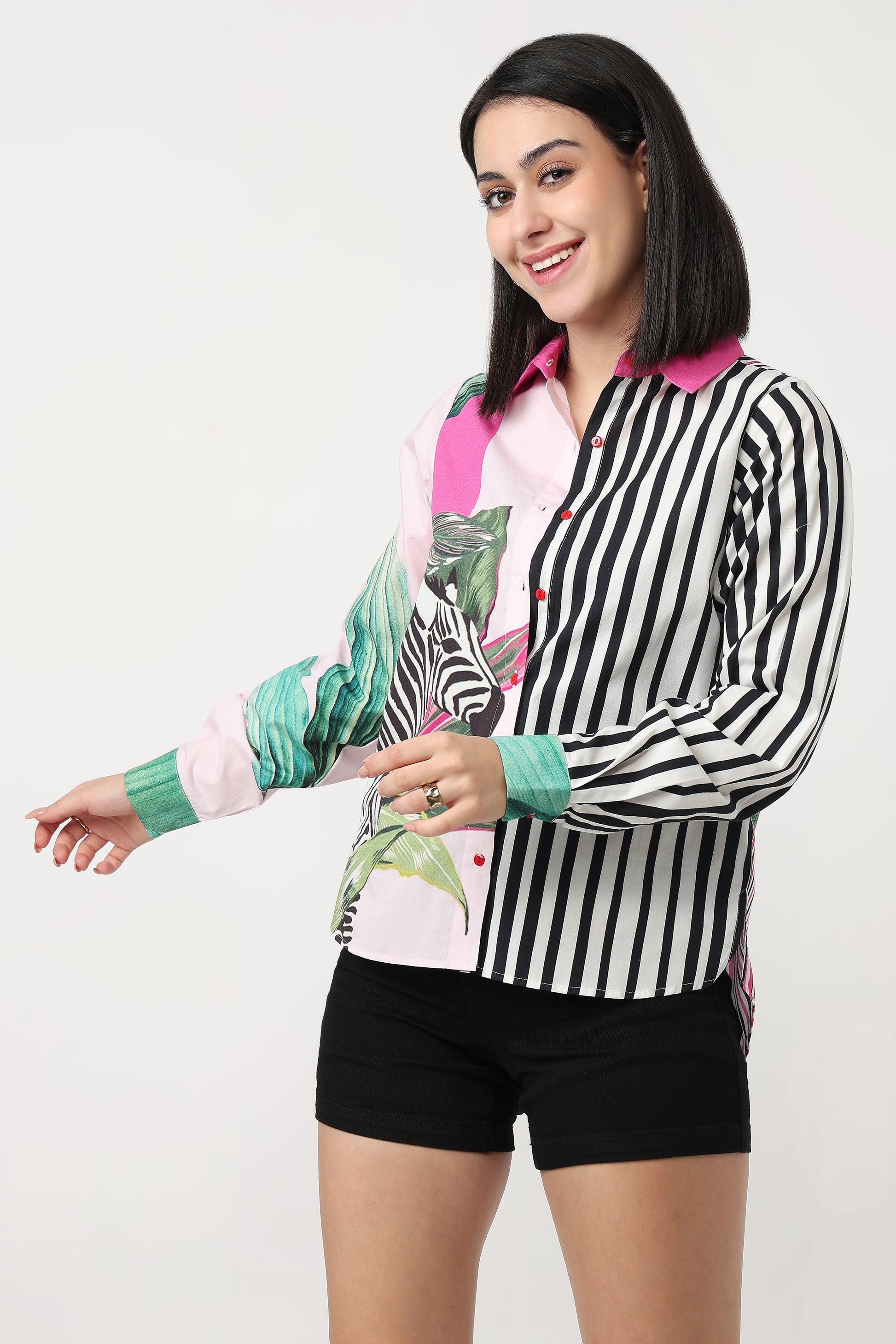 Woman wearing a black and white striped shirt with colorful sleeves on a white background