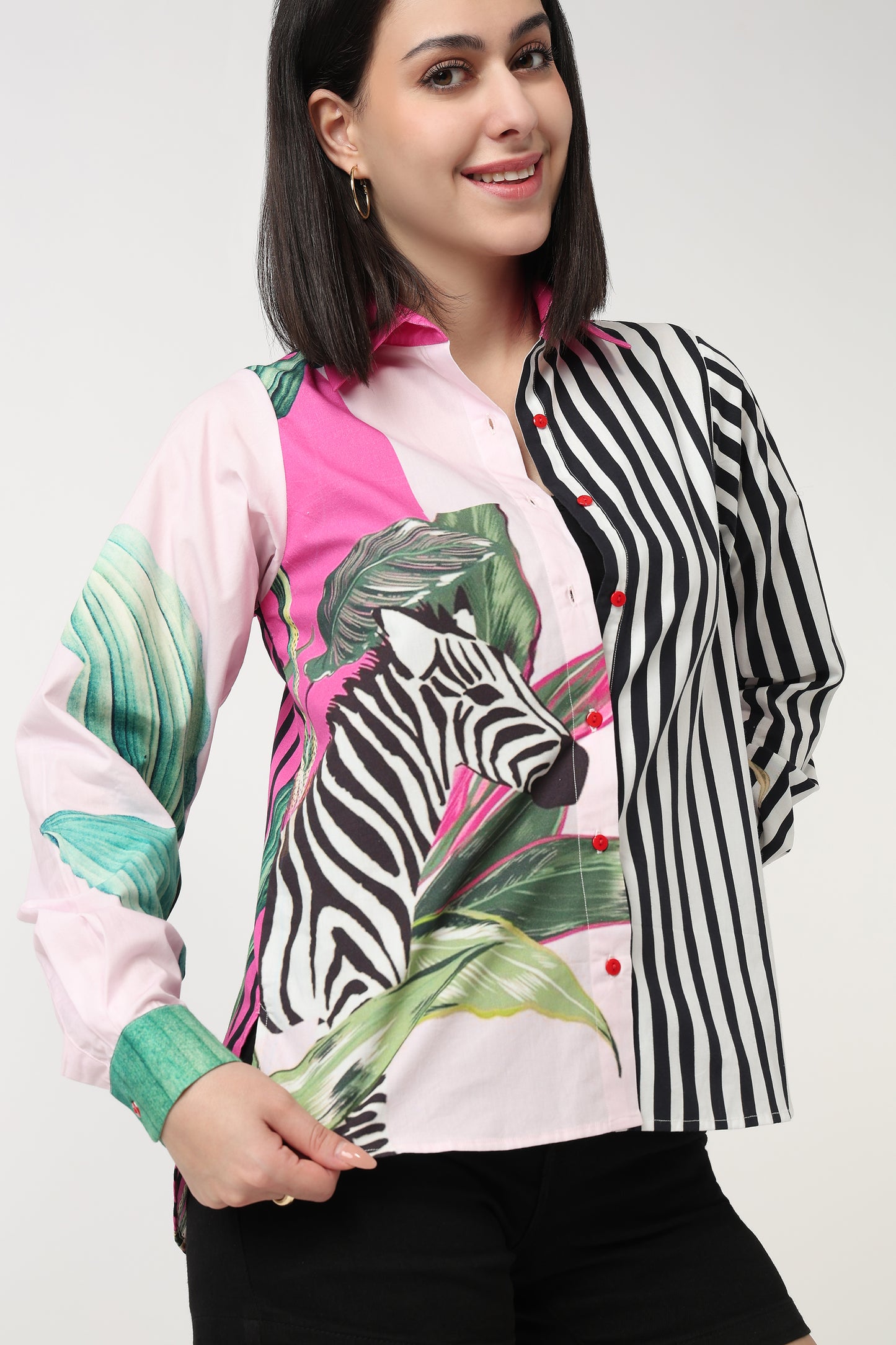 Woman wearing a colorful jacket with zebra and leaf patterns on a white background