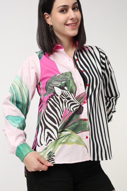Woman wearing a colorful jacket with zebra and leaf patterns on a white background